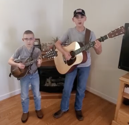 Brothers Jacob and Lucas Parker playing guitar